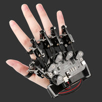 Mechanical glove with electronic components on a hand against a white background