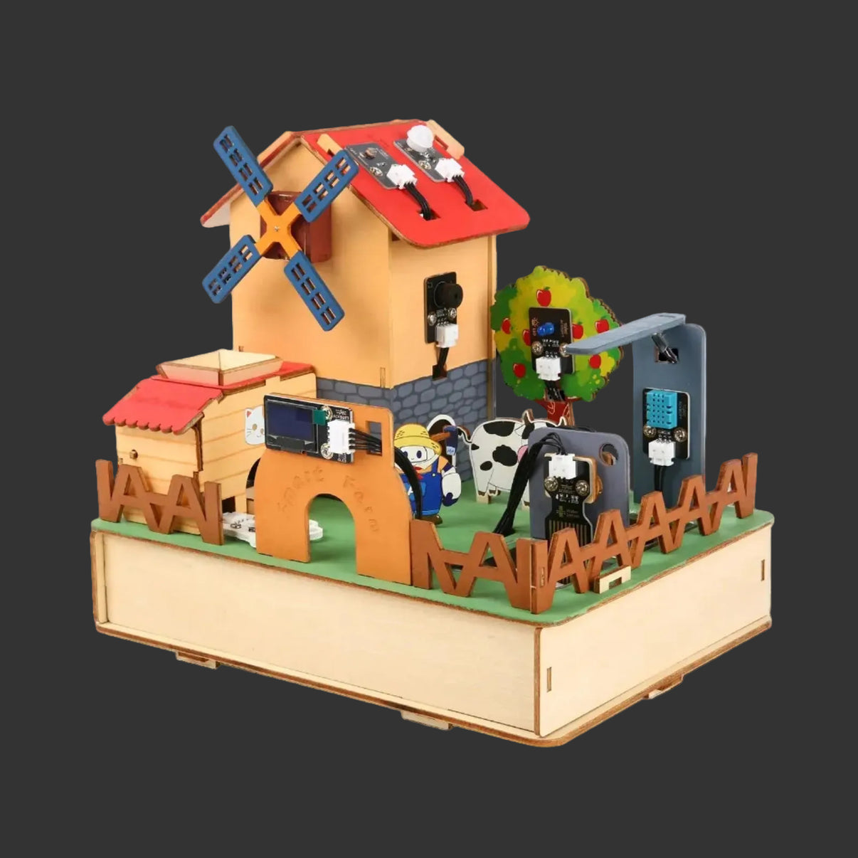 Toy farm set with buildings, animals, and windmill on a white background